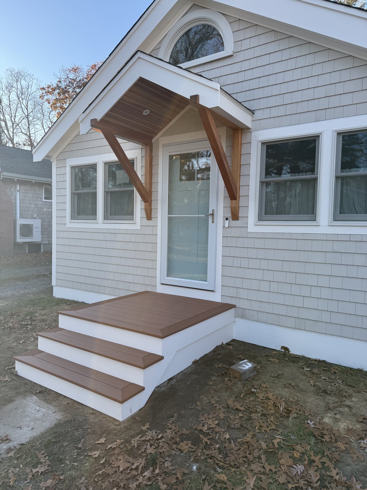 Front entry portico with mahogany timber brackets and composite step landing built by Perocchi Building & Remodeling, MA