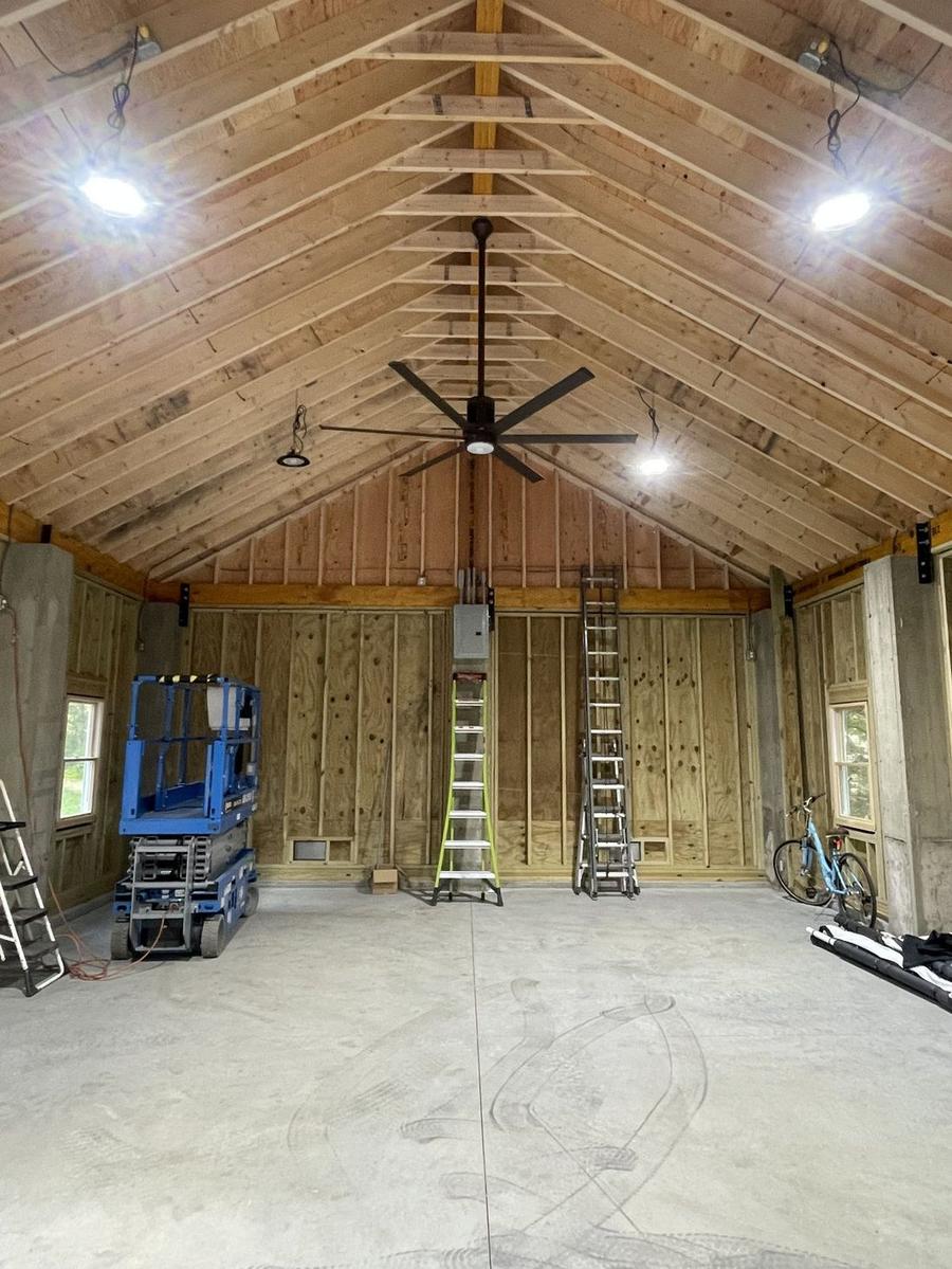 Custom vaulted ceiling framing with exposed rafters — new construction interior by Perocchi Building & Remodeling